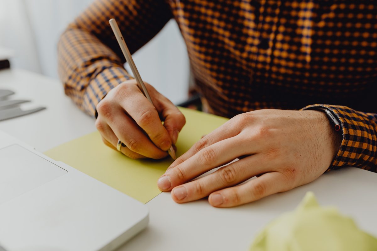 person writing on paper